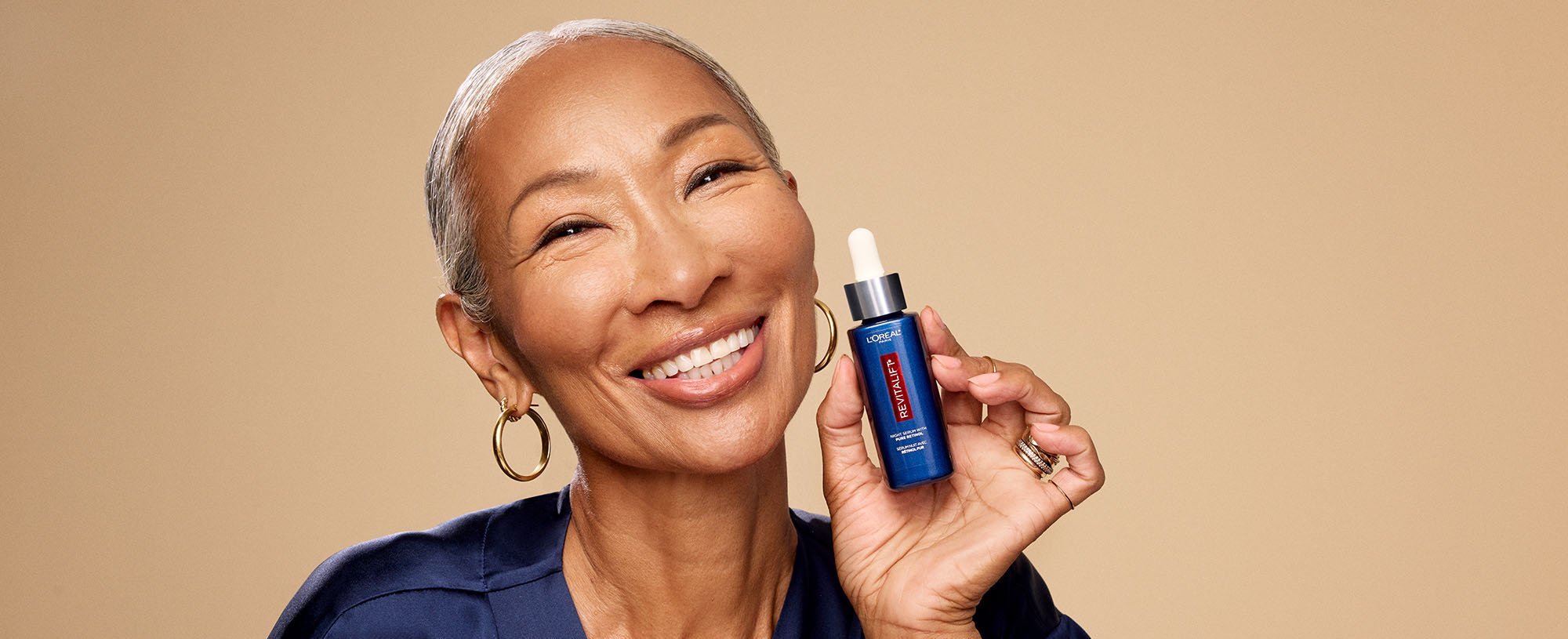 Person Holding A Loreal Paris Revitalift Serum