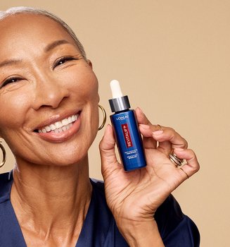 Person Holding A Loreal Paris Revitalift Serum