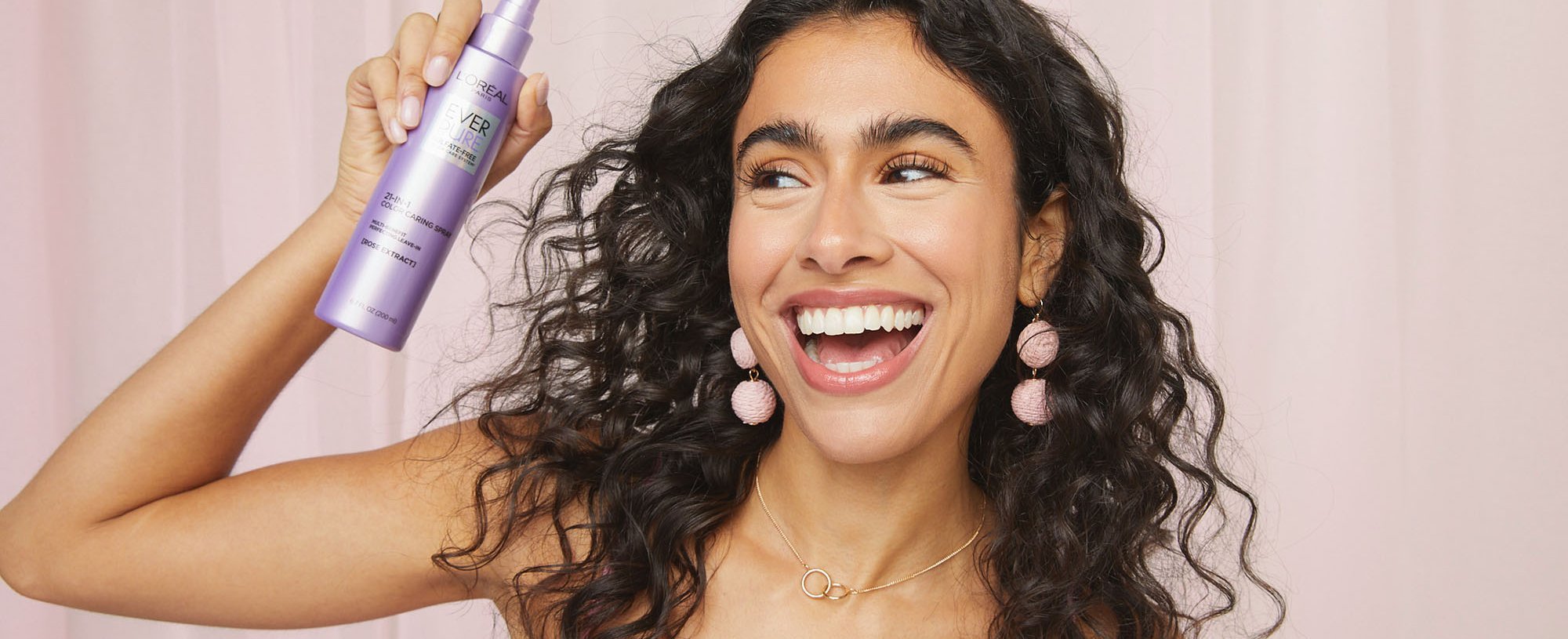 A Person Holding The LOreal Paris 21 In 1 Styling Spray To Tackle Tangled Hair