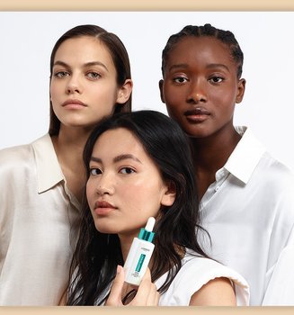 A Group Of People With One Person Holding The Loreal Paris Bright Reveal Niacinamide Serum For Dark