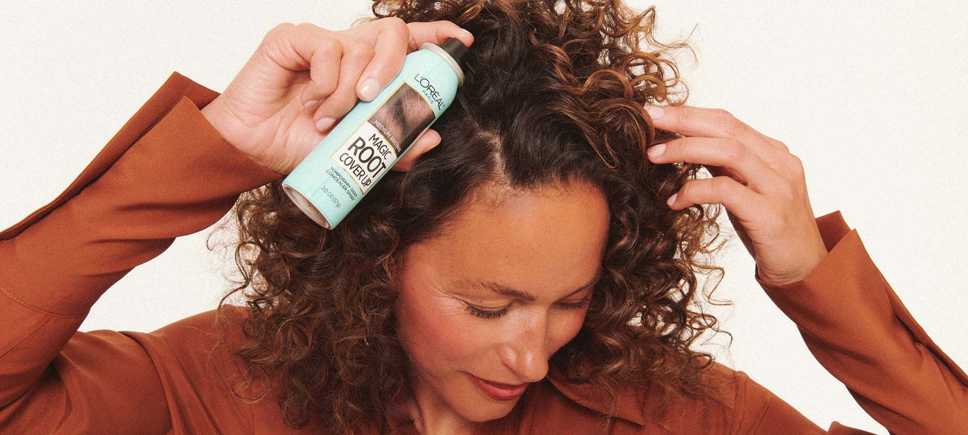 A Person Applying Loreal Paris Magic Root Spray On First Gray Hairs