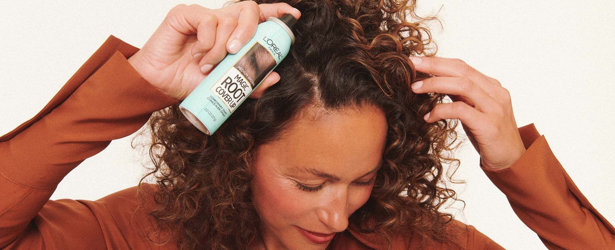 A Person Applying Loreal Paris Magic Root Spray On First Gray Hairs
