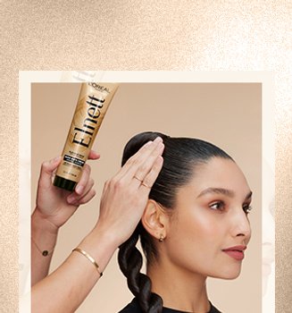 A woman with a sleek back ponytail