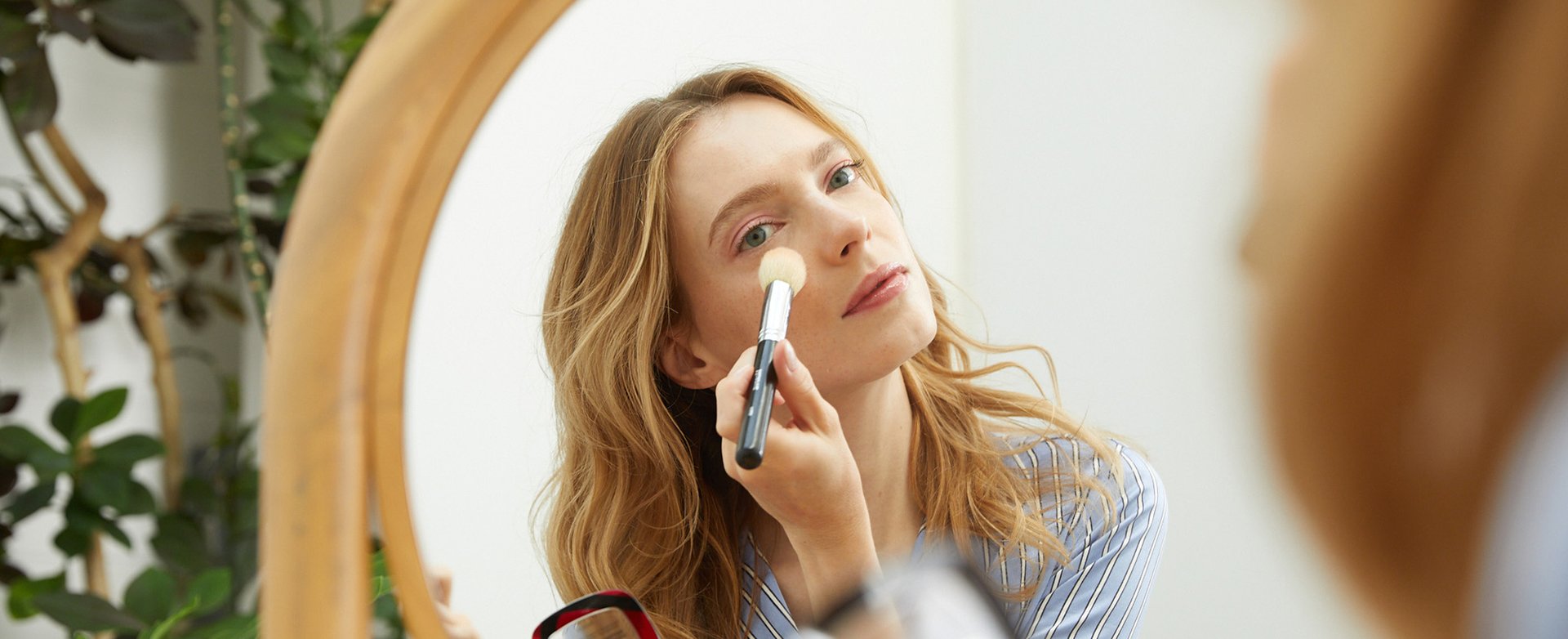 A woman using makeup brush