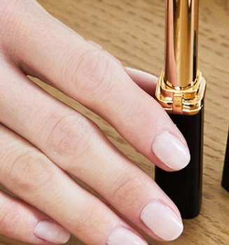 A woman wearing nude nail color