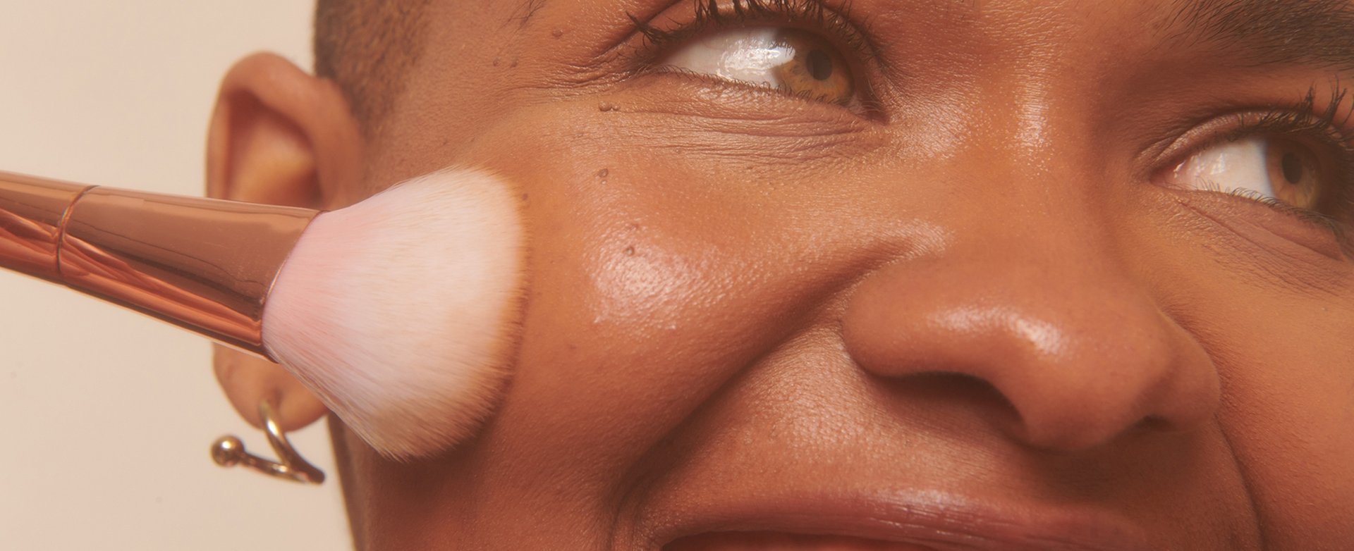 Woman applying blush to face