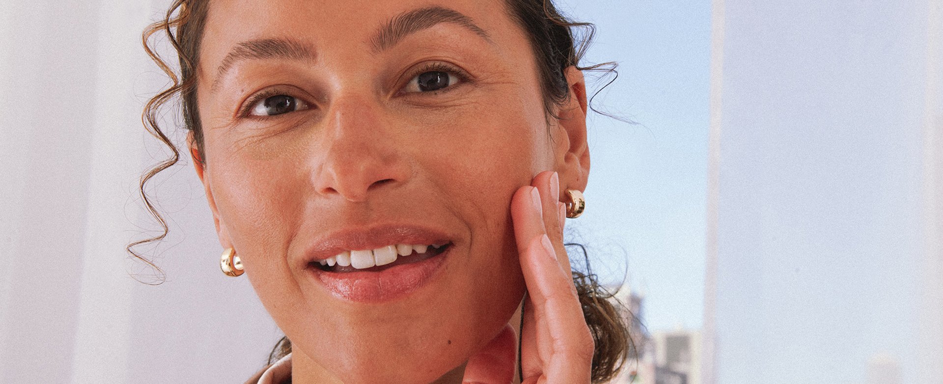 A lady touching their smooth face