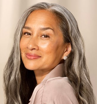 Smiling woman with long hair.