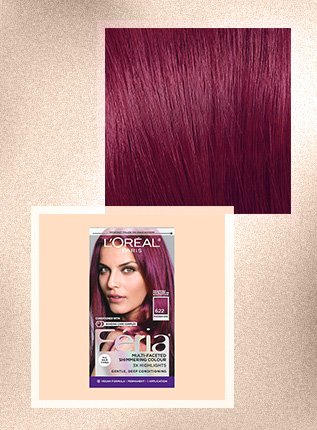 Woman with bold magenta hair color for dark hair, styled in loose waves to showcase the rich tones