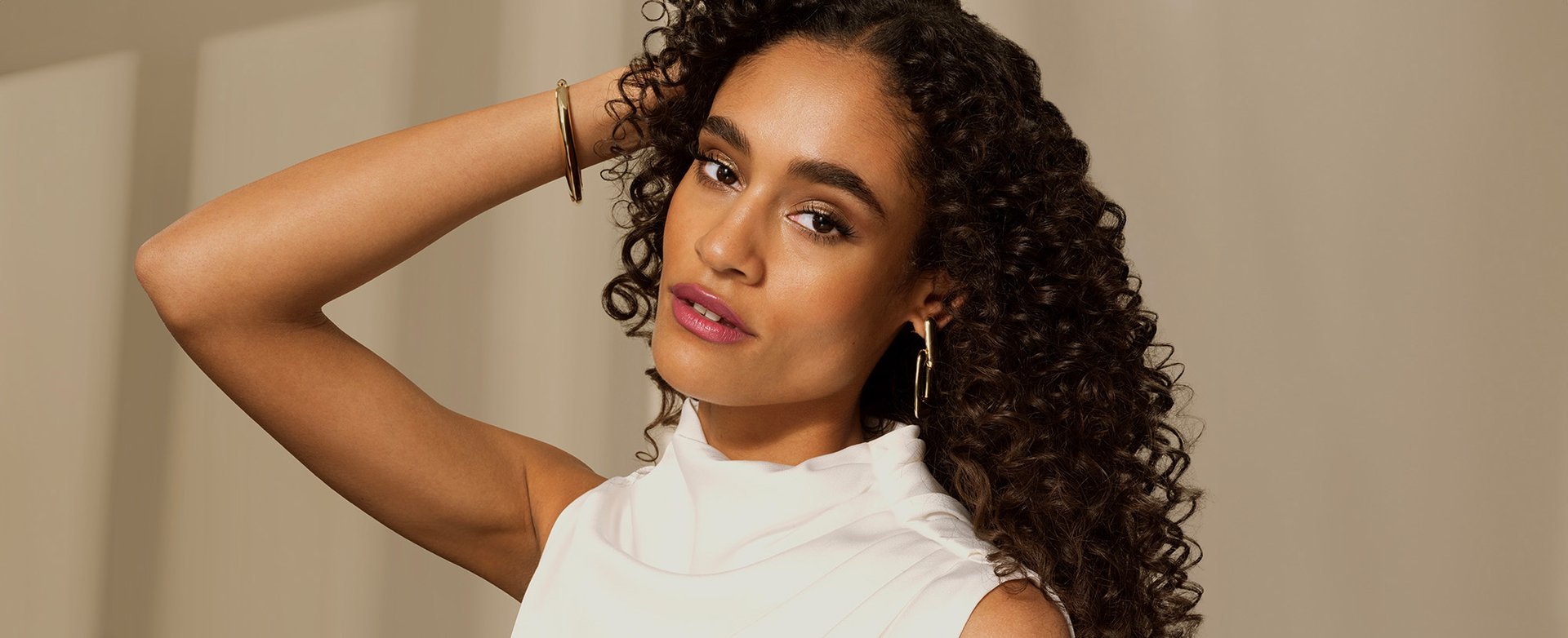 A woman with long curly brown hair
