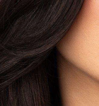 A woman applying lipstick to lips